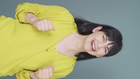 Vertical-video-of-Happy-woman-rejoices.